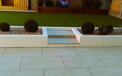 Gardening project with porcelain paving and raised lawn